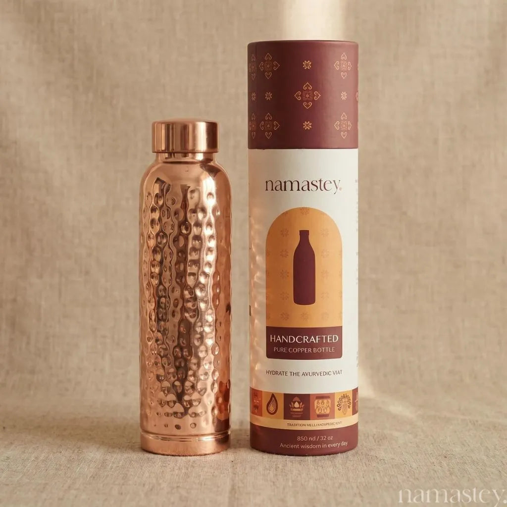 Classic hammered copper bottle beside its Namastey Handcrafted gift tube packaging