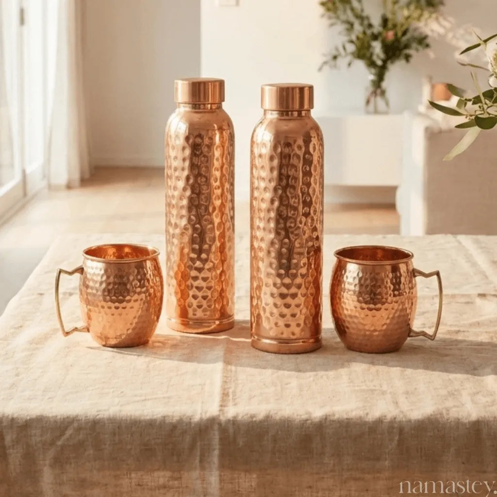 Daily Ritual set: 2 copper bottles and 2 mule mugs on a linen table